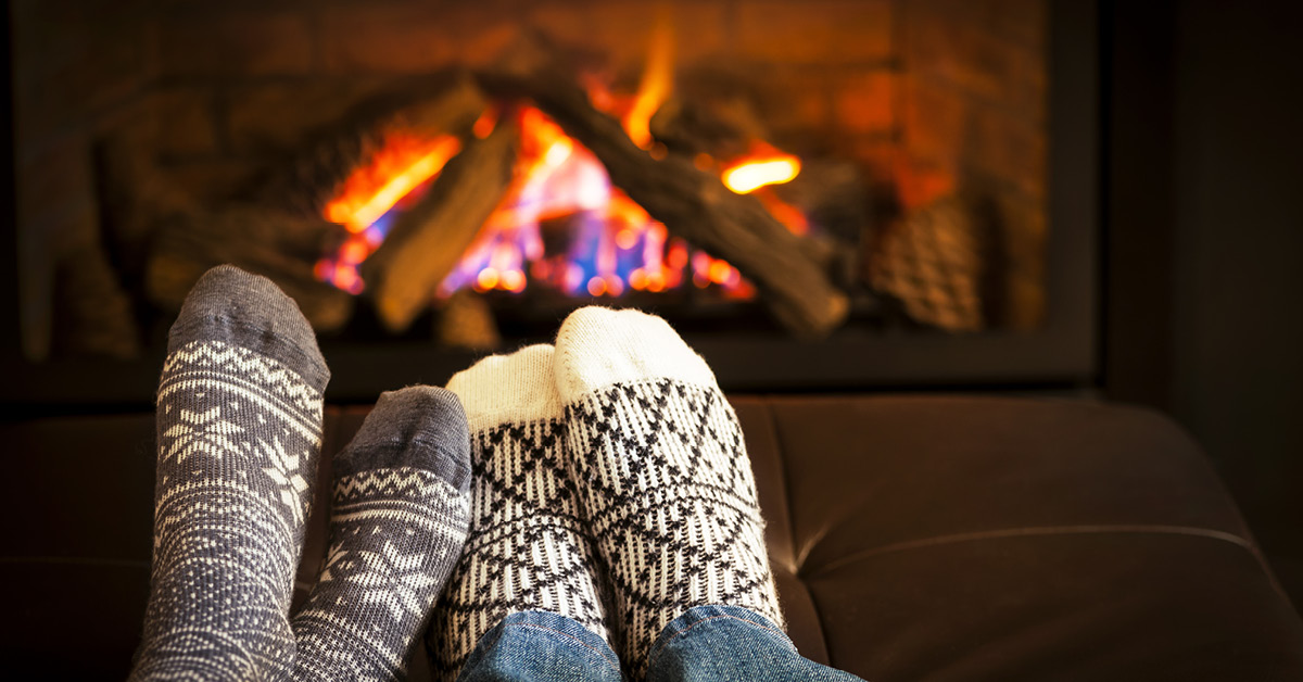 Feet by fireplace.